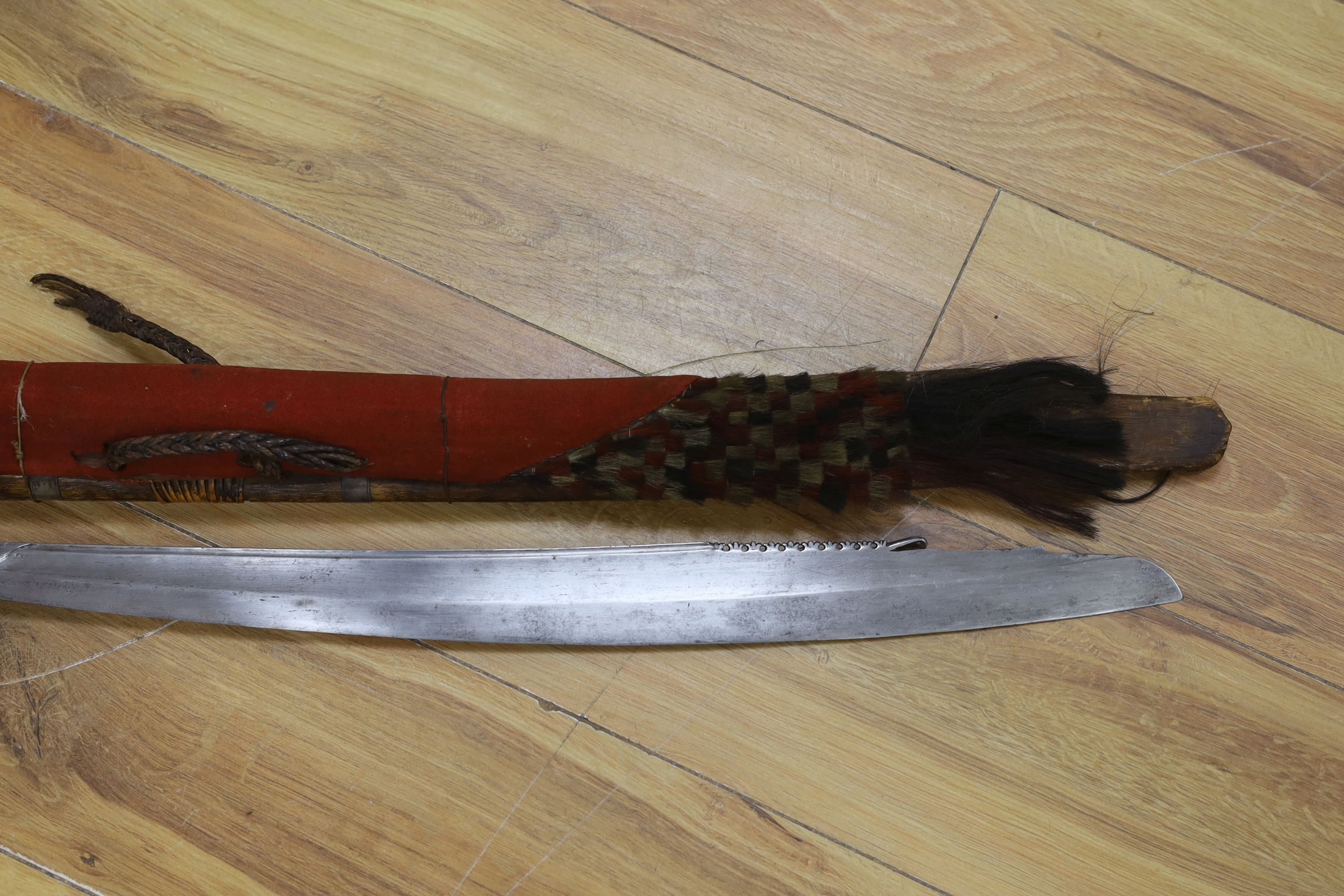 A Borneo 'headhunter's sword', a bone carving and feather swot (3), sword 77 cm long
